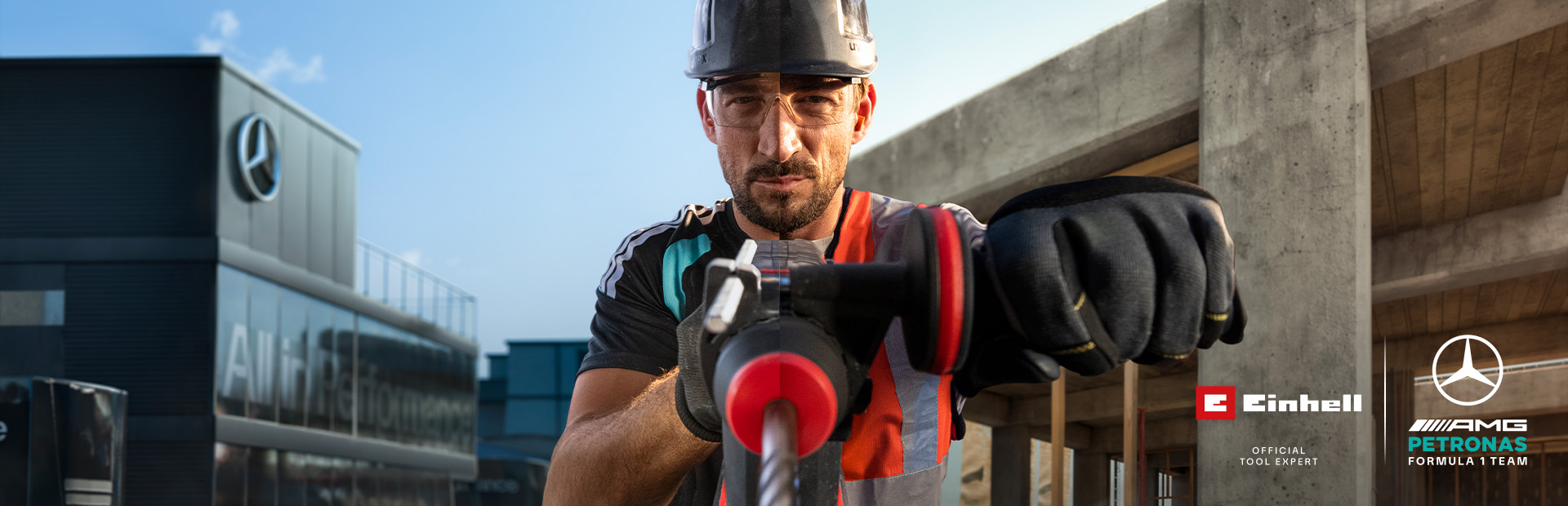 A mechanic in protective gear drilling with a power tool at a construction site.