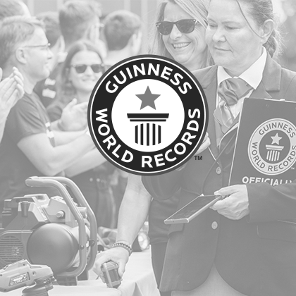 Black and white image: The Guinness World Records logo over an event photo showing Einhell tools.